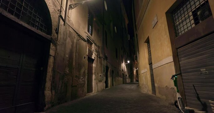 Rome Italy night street cityscape. Street lighting, old cobblestone houses in the center of the historical tourist center. High quality 4k footage