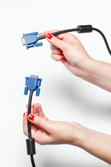 Video connector for a computer in the hands of a girl, connecting to a computer