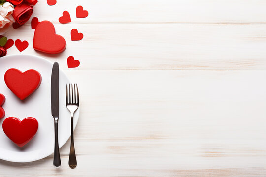 Valentines day table setting with red hearts and cutlery on wooden background