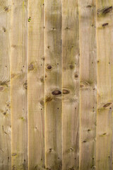 New wooden residential back yard garden fence background which is usually made of pine or larch wood, stock photo image