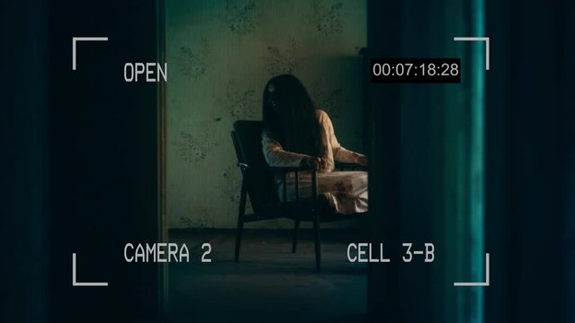 Creepy old woman with messy hair sitting in armchair and laughing, paranormal