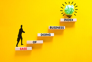 Ease of doing business index symbol. Concept words Ease of doing business index on wooden blocks. Beautiful yellow table yellow background. Business, ease of doing business index concept. Copy space.