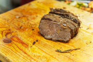 Slicing beef meat for Kazakh beshparmak. Preparation of horse meat by the chef for hot dishes. Cutting large pieces of meat into small slices