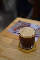 Frothy coffee on wooden table in a cafe