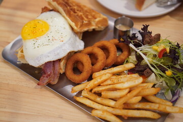 Delicious American breakfast with waffles and fried egg