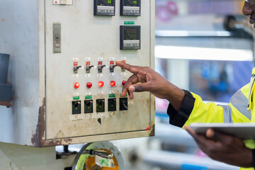 Close-up view of the hands of an African male engineer Pressing electronic circuit boards,...