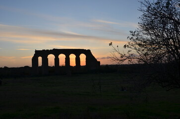 ancient roman aqueduct at sunset