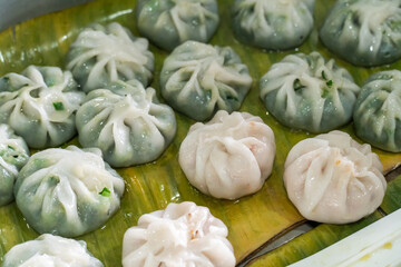 Steamed chives dumplings served in banana leaf tray. Thai traditional dessert. Traditional steamed...