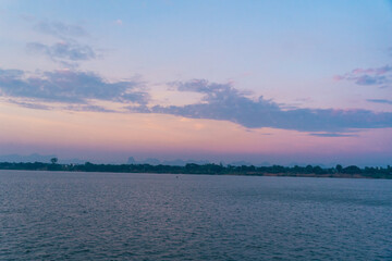 Twilight at Mekong River. The scenery in the morning of Laos along Mekong river with mountains, small villages and forest, Landscape of riverside between Thai and Laos border, Nakhon Phanom, Thailand