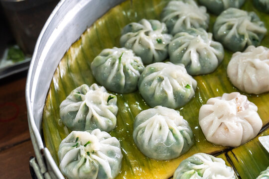 Steamed chives dumplings served in banana leaf tray. Thai traditional dessert. Traditional steamed vegetable dumplings consist of stir-fried taro or chives also known as Choi Pan or Chai Kwe