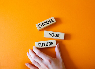 Choose your future symbol. Wooden blocks with words Choose your future. Beautiful orange...