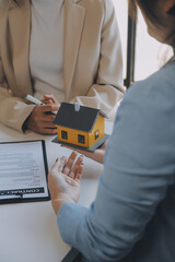 Real estate agent and customer signing contract to buy house, insurance or loan real estate.rent a house,get insurance or loan real estate or property.