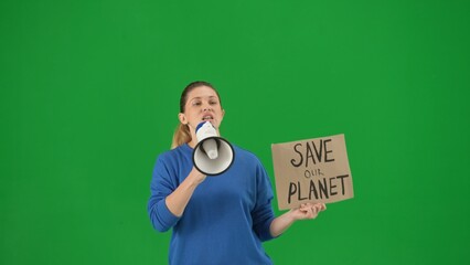 A woman speaks into a megaphone and holds a placard that reads Save Our Planet. Woman with a mouthpiece and a poster on a green screen close up. Save planet, climate changes concept, ecology.