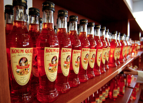 Corfu Island, Greece - June XX, 2008: bottles of liqueur made from Kumquat fruits in Mavromatis factory shop on Corfu Island