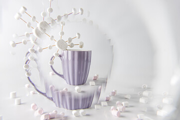 Hot cocoa with marshmallows in purple mug with snowflake. Handmade marshmallows snowflake. Swirl effect.