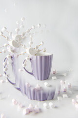 Hot cocoa with marshmallows in purple mug with snowflake. Handmade marshmallows snowflake. Swirl effect.