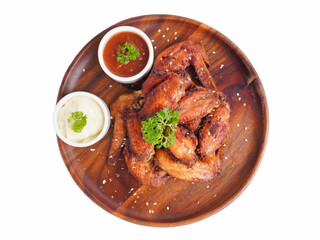Cooked grilled chicken wings marinated with seasonings Placed on an old wooden tray on a white background