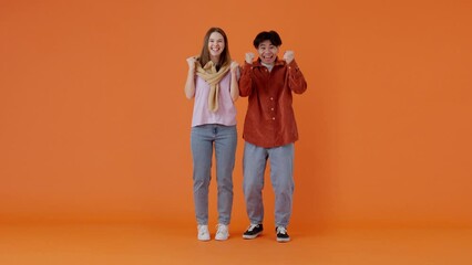 Couple of woman and man cheers for football team on TV