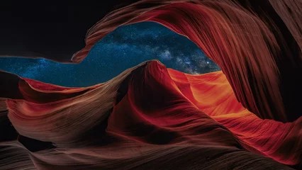 Poster Antelope Canyon at night with a beautiful starry sky at night with the galaxy in the background © emotionpicture