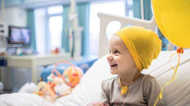 Young child in a hospital bed, smiling joyfully at a yellow balloon, wearing a headscarf