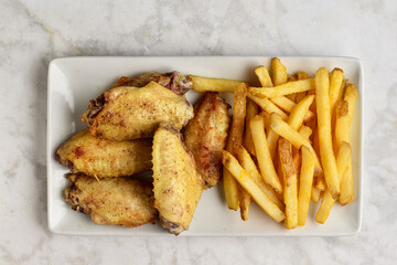chicken wings  served with french friesand barbecue sauce