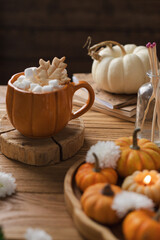 Pumpkin latte and decorative pumpkins nearby