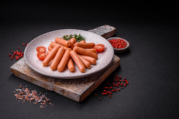 Fototapeta na wymiar Delicious small sausages with salt, spices and herbs