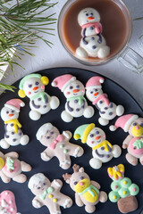 Fototapeta premium Christmas marshmallows. Winter candy. Sweet food in december. Snowman and Santa Claus