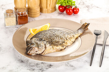 Baked Dorado fish served lemon