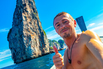 Tourist on Koh Phi Phi island Thailand with longtail boats.