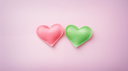 Handmade green and pink fabric hearts on a white background. Love, Valentine's Day, hobby, concept.