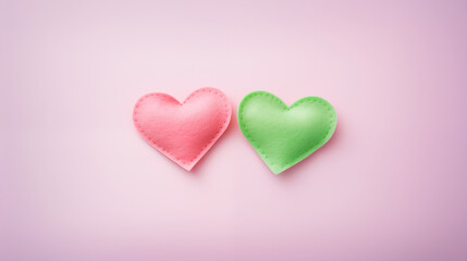 Obraz premium Handmade green and pink fabric hearts on a white background. Love, Valentine's Day, hobby, concept.