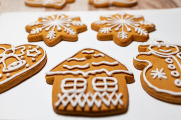 Christmas cookies are decorated and covered with white sugar icing. Ready to eat cookies