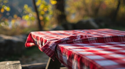 red cloth picnic tablecloth on the picnic table in autumn nature background