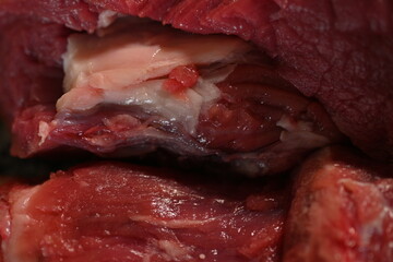 slices of red sliced beef meat, beef tenderloin, red meat on a grey background 	