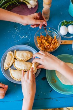 Personas comiendo empanadas.