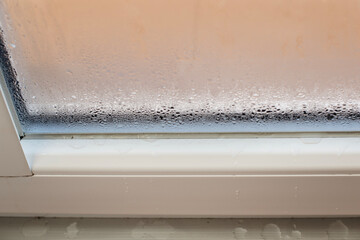Selective focus on water condensation on window glass. Humidity in the house. Home moisture.