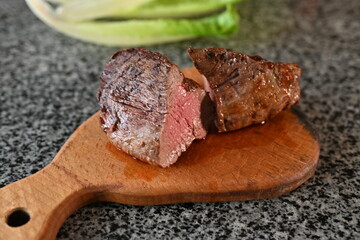fried veal steak cut into slices, fried to medium rare in a used dish with red sauce, food to raise haemoglobin, red meat 