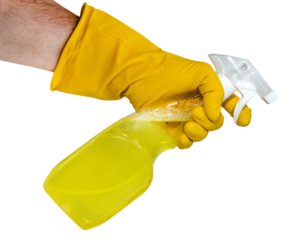 A hand in yellow rubber gloves holds a spray bottle with a cleaning or detergent on a white background. Rubber gloves isolate