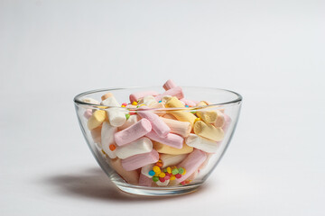 Marshmallows of different colors on a white background