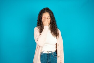 Young beautiful teen woman Yawning tired covering half face, eye and mouth with hand. Face hurts in pain.