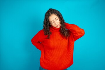 beautiful teen girl wearing red knitted sweater got back pain