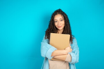 Fototapeta premium beautiful teen girl wearing denim jacket happy face smiling with crossed arms looking at the camera. Positive person.