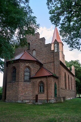 Fototapeta na wymiar A historic, Gothic Roman Catholic church dedicated to the Sacred Heart of Jesus in the village of Wartoslaw
