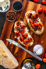 Mascarpone Toast with Burst Tomatoes: Slices of crusty bread topped with creamy cheese, charred...