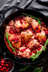 Rosemary Chicken Thighs with Cranberry Sauce: Boneless skinless chicken thighs cooked with cranberries garnished with fresh rosemary sprigs