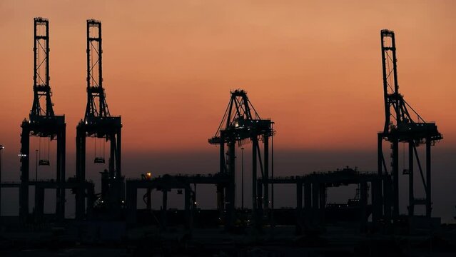view of giant cranes at sunset