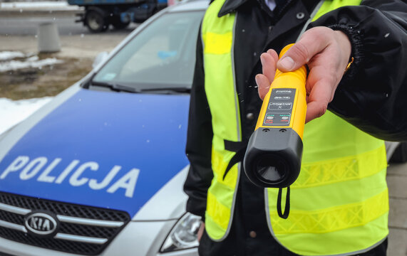 Warsaw, Poland - March 17, 2010: Policeman holds AlcoBlow alcohol meter for fast, preliminary drivers testing during field sobriety testing