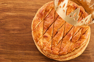 Epiphany cake on wooden table. Galette des rois traditional Epiphany cake in France
