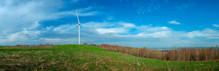 Fototapeta na wymiar Wind turbine for alternative energy in mountain landscape with clear space background. The concept of clean energy, eco-energetics of the wind.